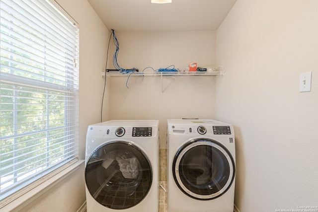 clothes washing area featuring a healthy amount of sunlight and separate washer and dryer