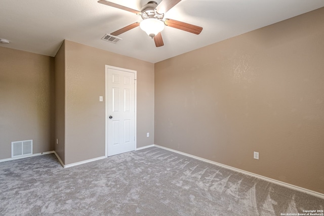 carpeted spare room with ceiling fan