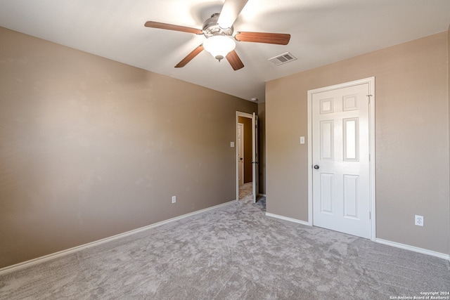 unfurnished bedroom with ceiling fan and light colored carpet