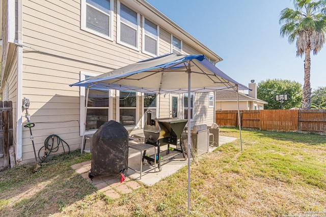 back of property with a yard and a patio