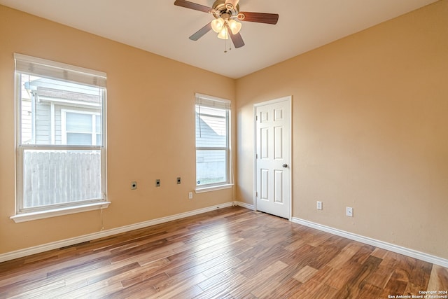 spare room featuring light hardwood / wood-style flooring and ceiling fan