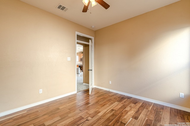 spare room featuring ceiling fan and light hardwood / wood-style flooring