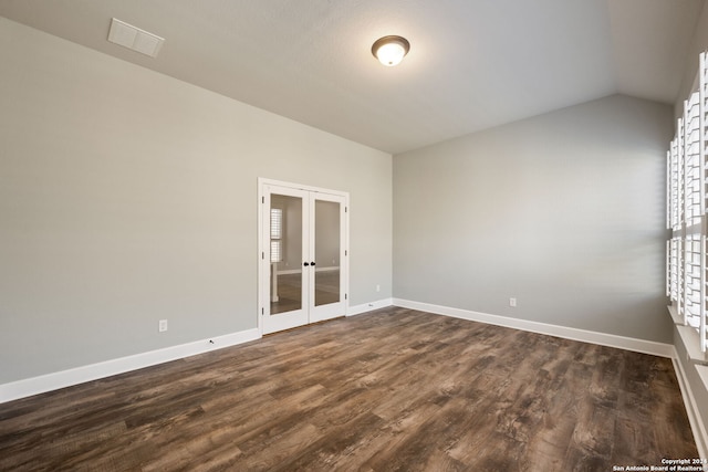 spare room with french doors, vaulted ceiling, and dark hardwood / wood-style flooring