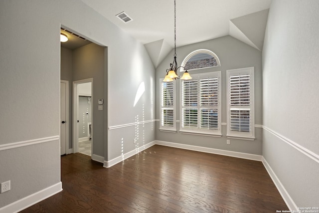 unfurnished dining area featuring dark wood-type flooring, lofted ceiling, and an inviting chandelier