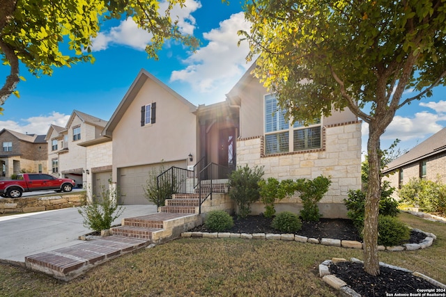 view of front of property with a garage and a front lawn