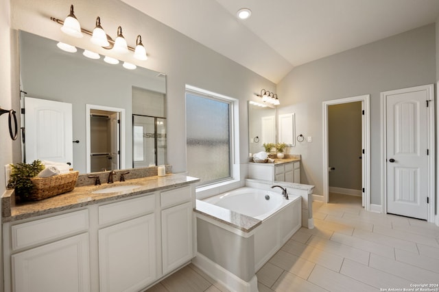 bathroom with lofted ceiling, shower with separate bathtub, tile patterned floors, and vanity