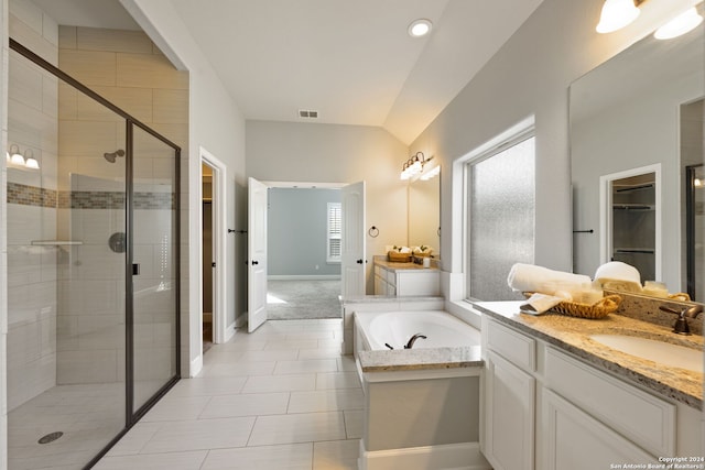 bathroom with tile patterned flooring, plus walk in shower, vaulted ceiling, and vanity