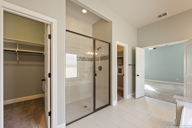 bathroom featuring tile patterned flooring and a shower with door