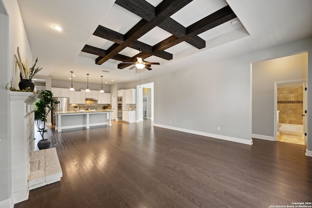 unfurnished living room featuring ceiling fan, dark hardwood / wood-style floors, beam ceiling, and coffered ceiling