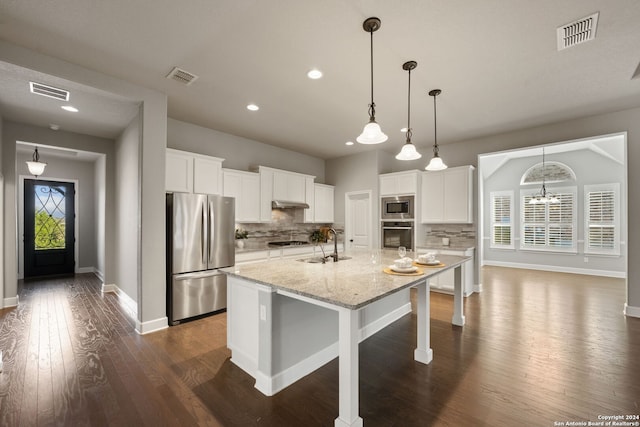 kitchen featuring a center island with sink, a wealth of natural light, white cabinetry, and stainless steel appliances