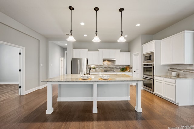 kitchen featuring stainless steel appliances, backsplash, and dark hardwood / wood-style floors