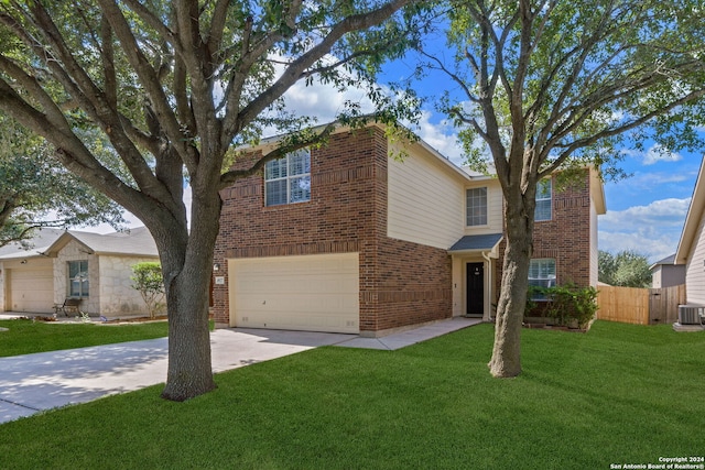 view of front of property featuring a front lawn, central air condition unit, and a garage