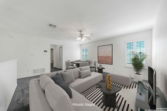 carpeted living room featuring ceiling fan