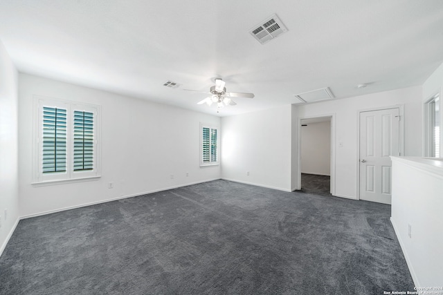 unfurnished room with dark carpet and ceiling fan