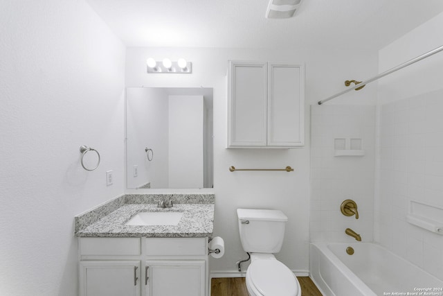 full bathroom with shower / bath combination, hardwood / wood-style floors, vanity, and toilet