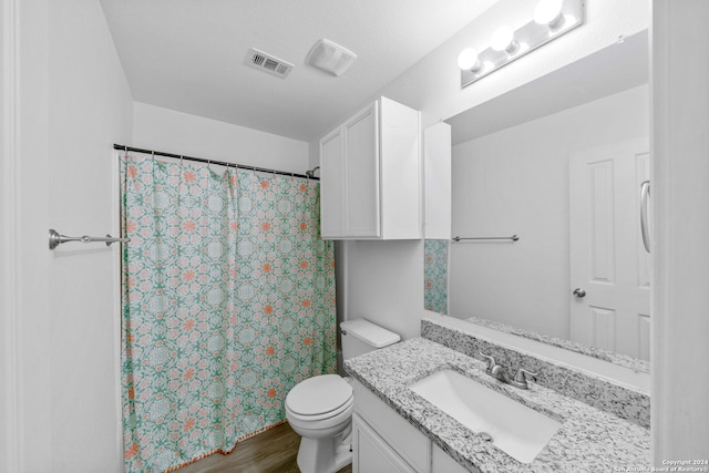 bathroom with walk in shower, hardwood / wood-style flooring, vanity, and toilet