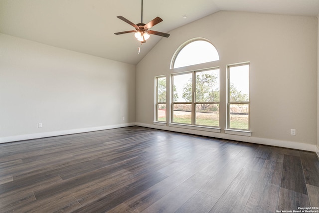 empty room with high vaulted ceiling, dark wood-type flooring, and ceiling fan