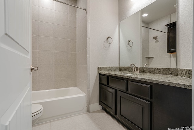 full bathroom featuring vanity, toilet, tile patterned floors, and tiled shower / bath