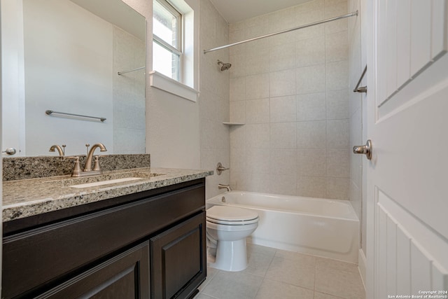 full bathroom featuring toilet, tiled shower / bath, vanity, and tile patterned floors