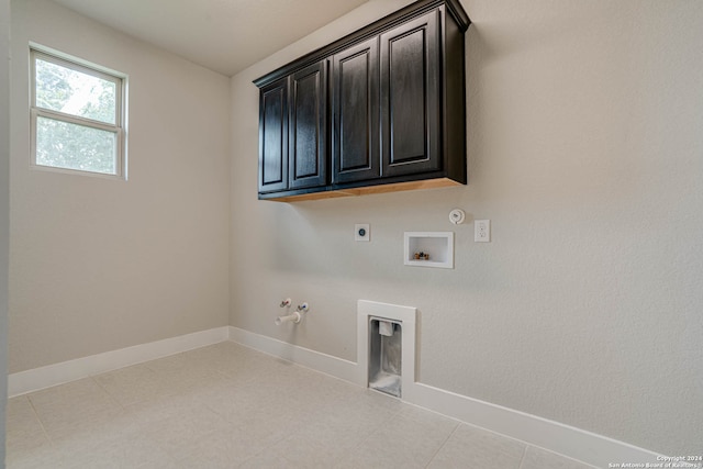 clothes washing area with hookup for an electric dryer, cabinets, gas dryer hookup, and hookup for a washing machine