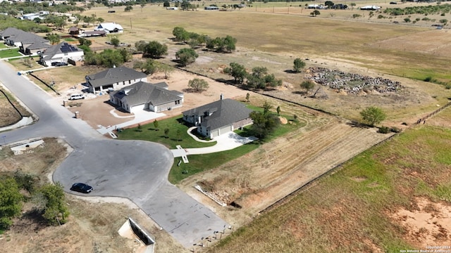 birds eye view of property with a rural view