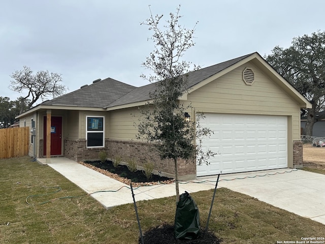 ranch-style house with a garage and a front lawn