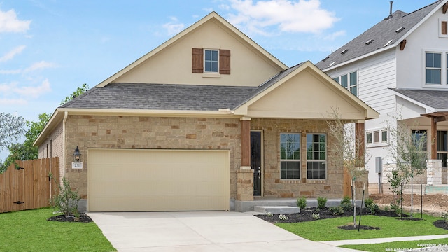 view of front of home with a garage and a front lawn