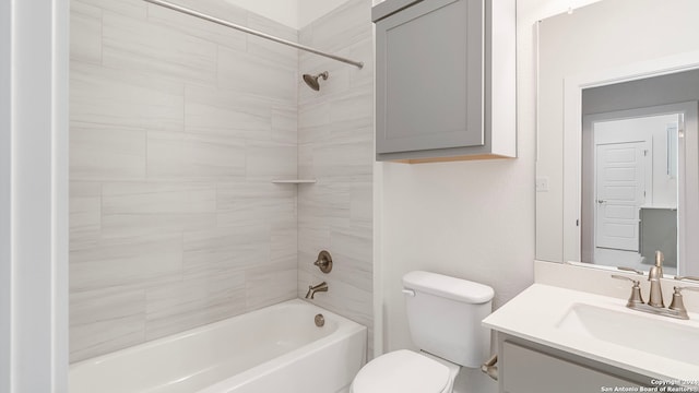 full bathroom featuring tiled shower / bath combo, vanity, and toilet