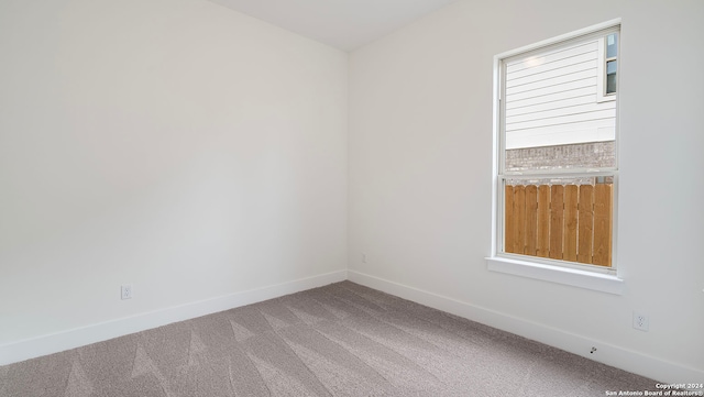 unfurnished room featuring carpet flooring