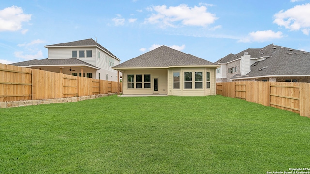 rear view of property featuring a patio area and a lawn