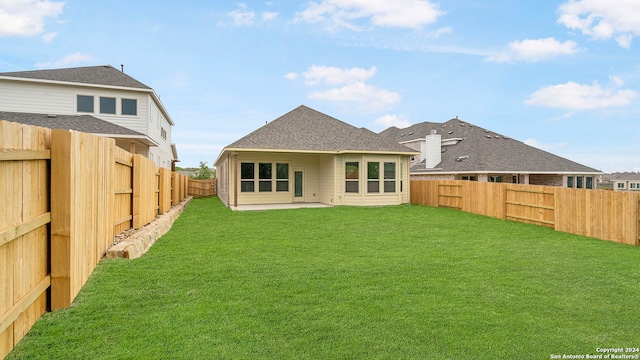 rear view of property with a patio area and a yard