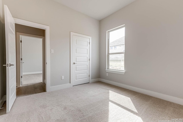 unfurnished bedroom with a closet and carpet flooring