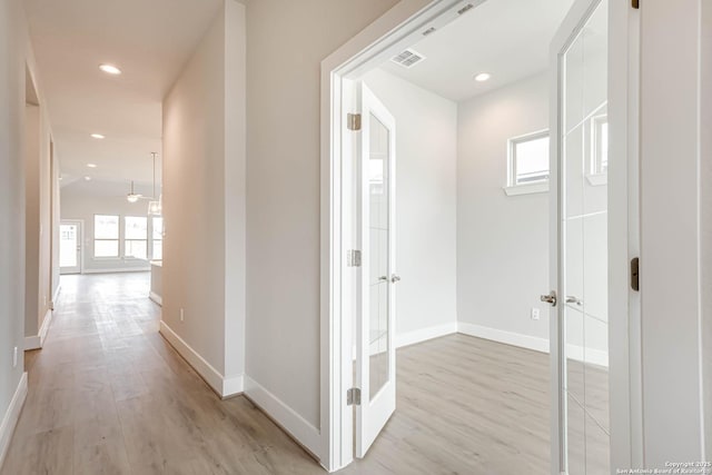 corridor featuring light hardwood / wood-style floors