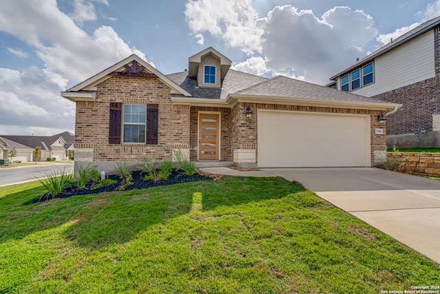 view of front of house with brick siding, driveway, an attached garage, and a front yard