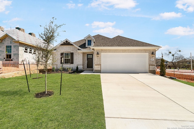 view of front of home featuring a front yard and a garage