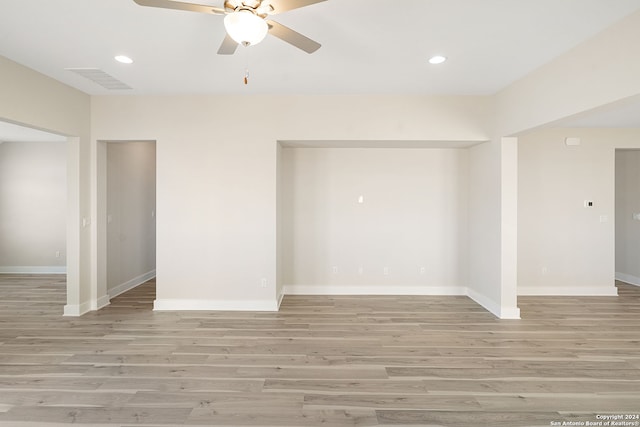 spare room featuring ceiling fan and light hardwood / wood-style flooring