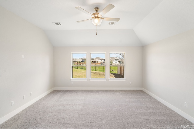 unfurnished room with ceiling fan, vaulted ceiling, and carpet floors