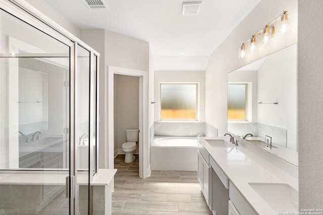 full bathroom featuring toilet, independent shower and bath, vanity, and wood-type flooring