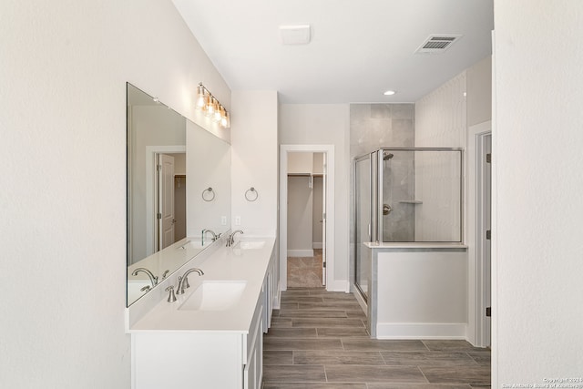 bathroom featuring vanity, hardwood / wood-style floors, and walk in shower