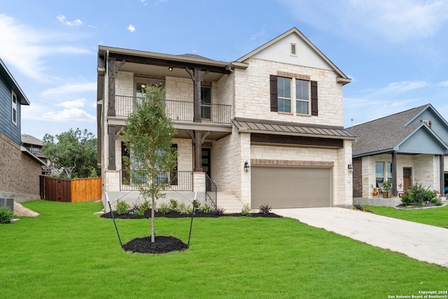 view of front of house featuring a garage, a front yard, and a balcony