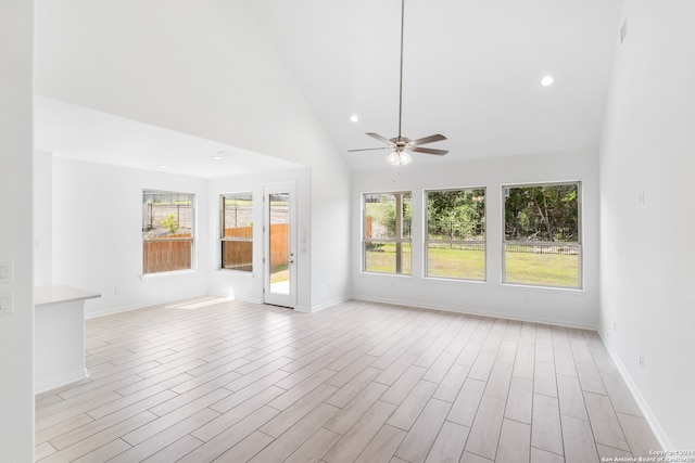 interior space featuring ceiling fan, high vaulted ceiling, a wealth of natural light, and light hardwood / wood-style floors