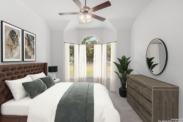 carpeted bedroom featuring ceiling fan and vaulted ceiling