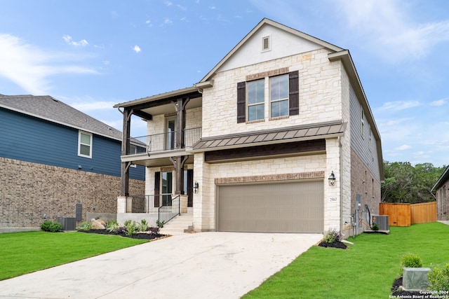 view of front of house with cooling unit, a balcony, a front yard, and a garage