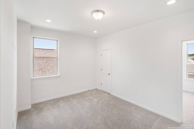 spare room with light carpet