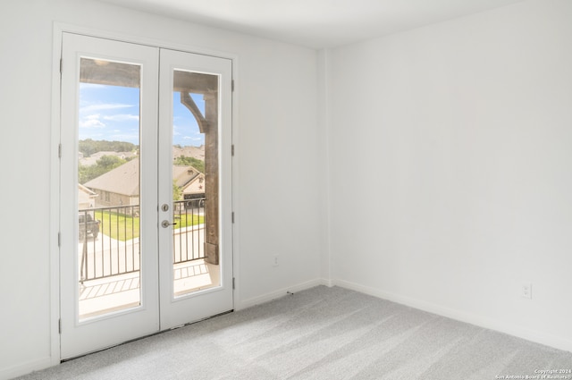 doorway to outside with french doors and light colored carpet