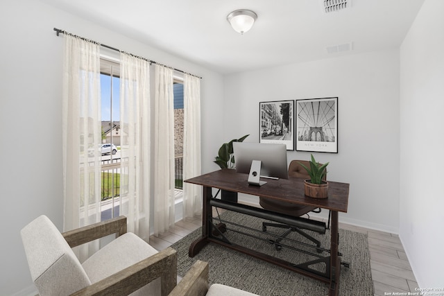 office with light hardwood / wood-style flooring