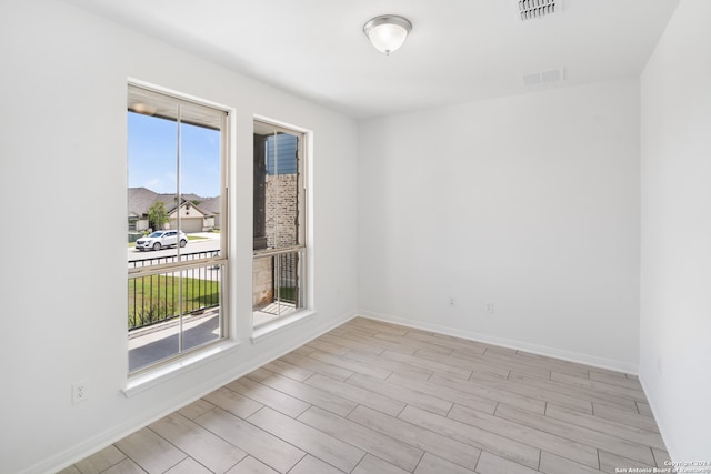 unfurnished room with light hardwood / wood-style floors