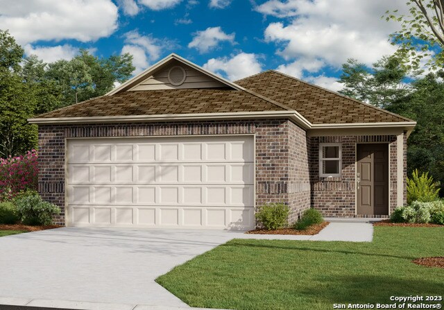 view of front of house with a garage and a front lawn