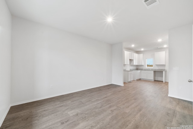 unfurnished living room with hardwood / wood-style floors