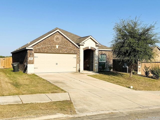 single story home with a front lawn and a garage